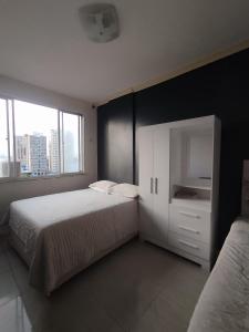 a bedroom with two beds and a white cabinet at Nosso lar in Belém