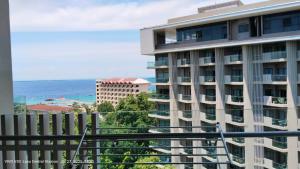 a view of the ocean from a balcony of a building at Rent Homecation at Tambuli Seaside Living in Maribago