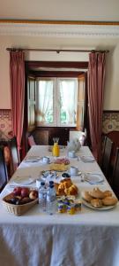 a table with plates of food and bread on it at Solar da Salvadoura in Amares