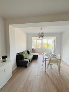a living room with a table and a couch at CALARREONA - Apartamento a 100 metros de la playa in Águilas
