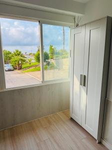 an empty room with a large window and a door at CALARREONA - Apartamento a 100 metros de la playa in Águilas
