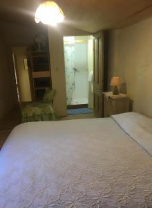 a bedroom with a large white bed and a door at Appartement 1 in Montboucher-sur-Jabron