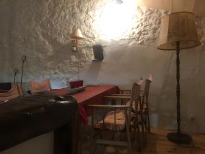 a room with a table and chairs and a lamp at Appartement 1 in Montboucher-sur-Jabron +6 photos