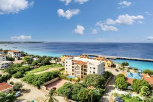 an aerial view of a resort with the ocean in the background at Playa Breeze Apartment in Kralendijk