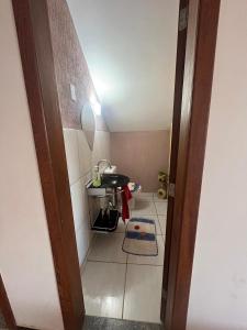 a room with a bathroom with a sink and a mirror at Casa 4 quartos in Porto Seguro