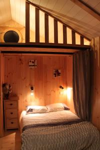 a bedroom with a bed with a wooden wall at Shangri La in Saint-Jean-Saint-Nicolas +19 photos