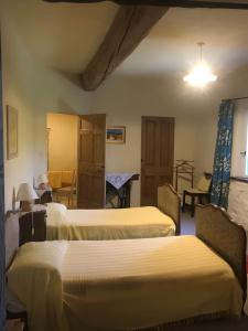 a room with four beds in a room at Appartement 2 in Montboucher-sur-Jabron