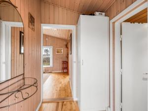 an open hallway with wood paneled walls and a door at Holiday Home Bosi - 100m to the inlet by Interhome in Højslev +14 photos