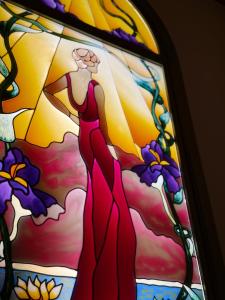 a stained glass window of a woman in a dress at Casa Espeñuela in Ojén +5 photos