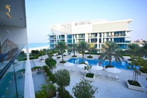 a view of a resort with a pool and a building at SeaBreeze Townhouse Mamsha Al Saadiyat in Abu Dhabi