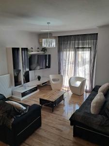 a living room with a couch and a table at KilkisLuxuryApartment in Kilkis