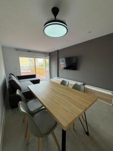 a living room with a wooden table and chairs at Apartamento en el centro de Móstoles in Madrid