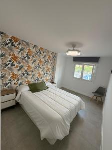 a bedroom with a large white bed in a room at Apartamento en el centro de Móstoles in Madrid +9 photos