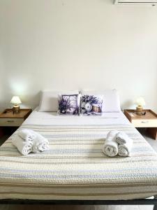 a bedroom with a bed with towels on it at Garden House in Olbia