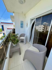 a balcony with two chairs and a table at Bayahibe Apartment by the Beach in Bayahibe +3 photos
