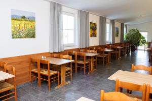 a dining room with wooden tables and chairs at OEKOTEL Traiskirchen in Traiskirchen