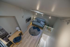 an overhead view of a living room with a blue couch at MAYA Apartments - Thorvald Meyers gate 38 in Oslo
