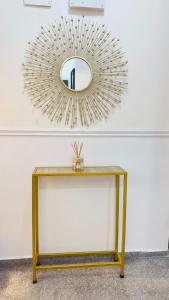 a mirror sitting on top of a table with a table at Zen Loft Terrace Maitama Abuja in Abuja