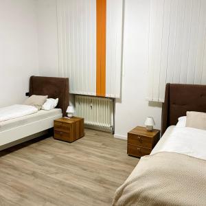a room with two beds and two night stands at Maxhaus 1 in Thüngen +32 photos