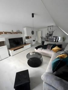 a white living room with a couch and a table at Zum Weserstrand in Hagen OT Rechtenfleth +37 photos