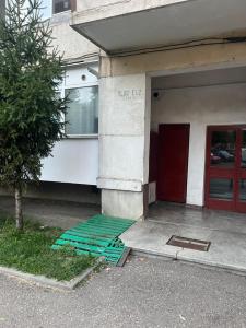 a building with a green mat outside of it at Noble Stay in Curtea de Argeş