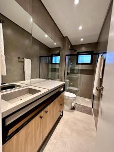 a bathroom with a sink and a toilet at Brava Paradise in Cabeçudas