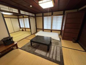 a room with a bed and a table in it at 緋乃里 in Nagahama