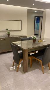 a dining room with a wooden table and chairs at H&d abrrtment hotel 5 in Cairo