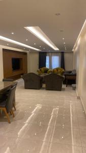 a living room with couches and a flat screen tv at H&d abrrtment hotel 5 in Cairo