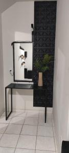 a desk with a mirror and a plant on it at Cozy Kitnet on Costa Beach in Vila Velha