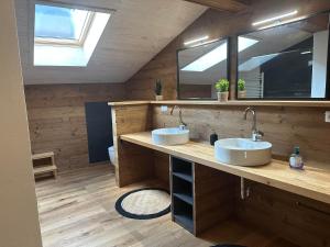 a bathroom with two sinks and a mirror at Fritz Alpchalets - Haus Lechtal in Vorderhornbach +99 photos