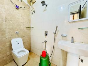 a bathroom with a toilet and a sink at Hotel Bay Suite Premium Near Sea Beach And Jagannath Temple - Free Wifi & Parking, Room service, Hygiene & Spacious Rooms, Available, Fully Air Conditioning Hotel - Prime Location # Best Hotel In Puri in Puri +26 photos