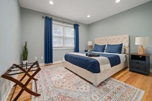a bedroom with a king sized bed and blue curtains at 3BR Apt Near Train Balcony Yonkers in West Mount Vernon