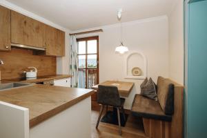 a kitchen with a table and a dining room at Almrausch in Alpendorf