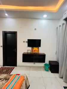 a living room with a flat screen tv on a wall at Galaxy royal studio 1 in Noida