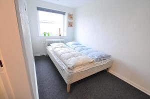 a small bed in a room with a window at 70035-Ulfborg-Vinkelvej-2 in Thorsminde