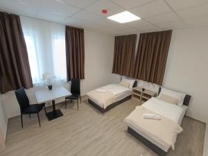 a hospital room with two beds and a table at Szatmári Apartman in Szekszárd