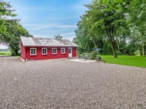 a red house with a gravel driveway at Holiday Home Saran - 30km from the sea by Interhome in Toftlund +15 photos