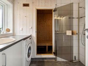 a bathroom with a sink and a washing machine at Holiday Home Tayana - 700m from the sea by Interhome in Neder Lysabild +19 photos