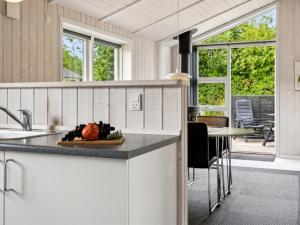 a kitchen with a counter with a plate of fruit at Holiday Home Tayana - 700m from the sea by Interhome in Neder Lysabild