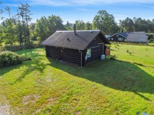 an aerial view of a log cabin in a field at Holiday Home Barni - 7km from the sea by Interhome in Ebeltoft