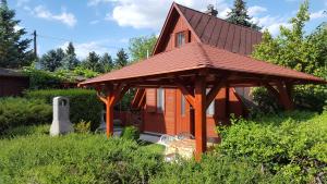 a small house with a gazebo in the yard at Kéri Apartman in Mosonmagyaróvár