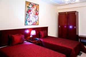Postel nebo postele na pokoji v ubytování Orchidea Hotel