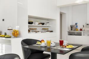 a kitchen with a table and chairs with food on it at Eurogarden Hotel in Rome +35 photos