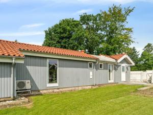 a gray house with a red roof at Holiday Home Salvina - 300m from the sea by Interhome in Odder