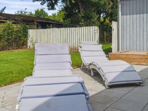 a group of lounge chairs sitting on a patio at Holiday Home Salvina - 300m from the sea by Interhome in Odder +18 photos