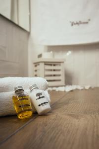 two bottles of honey and towels on a wooden floor at Filoxenion in Nafplio +104 photos