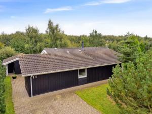 a black house with a brown roof at Holiday Home Eljena - 700m from the sea by Interhome in Neder Lysabild