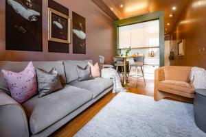 a living room with a couch and a dining room at Bijou Suite15 in Plymouth