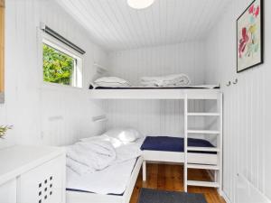 a room with two bunk beds and a window at Holiday Home Bedine - 1-3km from the sea by Interhome in Gilleleje